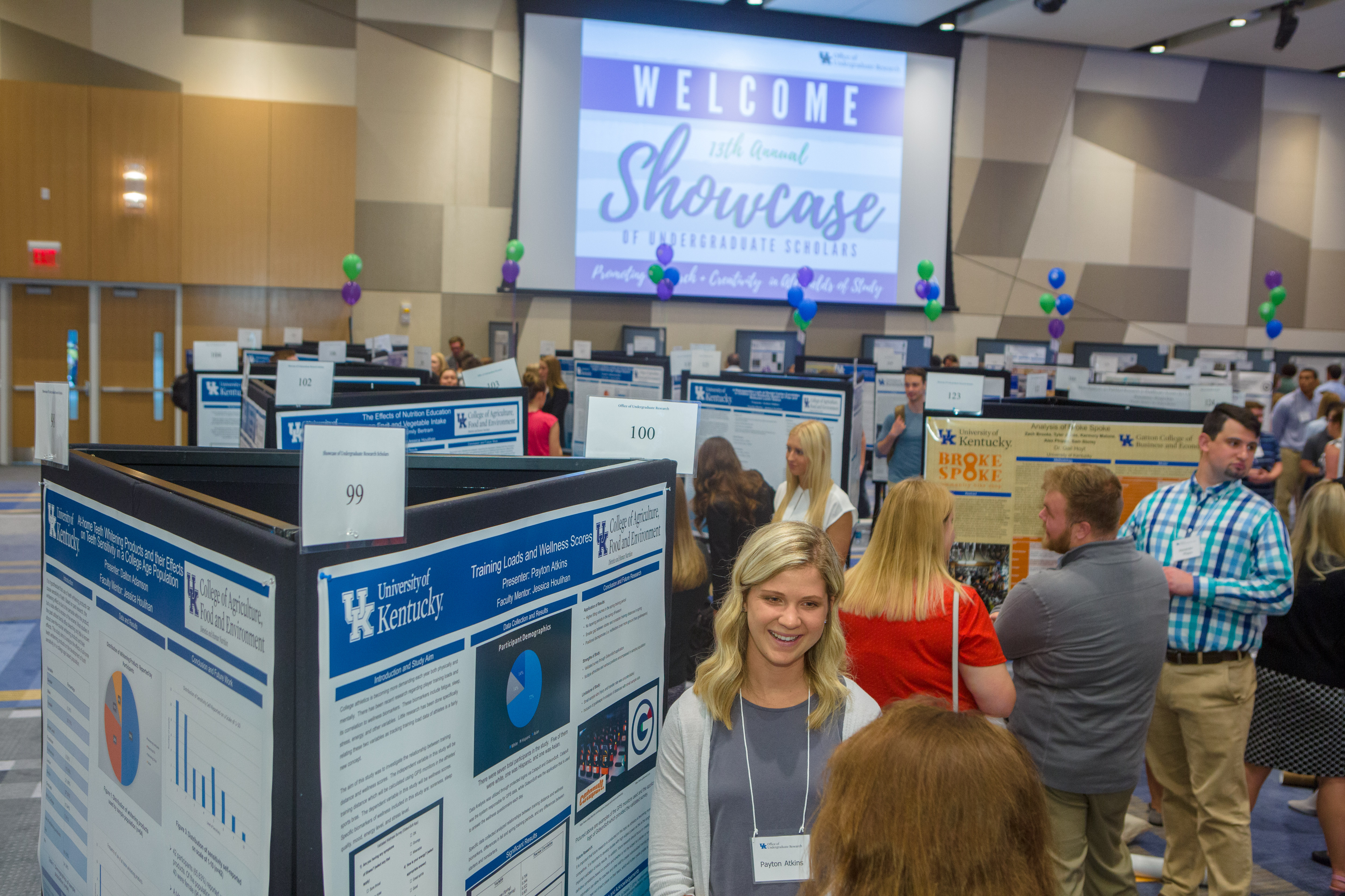 Students presenting research posters at conference